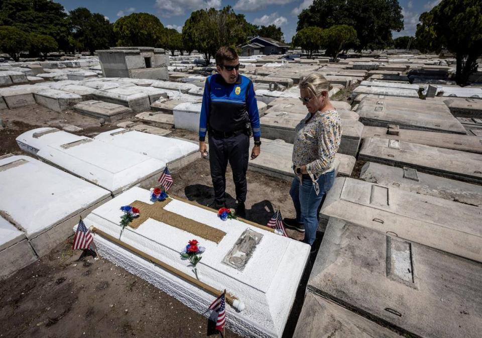 Miami, Florida, May 7 2021 - Commander Dan Kerr, left and retired Miami Detective Jerry Lynn Dellamico stand over what they believe to be Nathaniel Broom’s grave at Lincoln Memorial Park in Allapatah. Kerr is currently looking into scanning the grave so they can confirm the identity of the remains inside