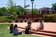 A group of young women eat lunch outside on the day restaurants and theaters are allowed to reopen to the public as part of the phased reopening of businesses from the coronavirus disease rules in Smyrna