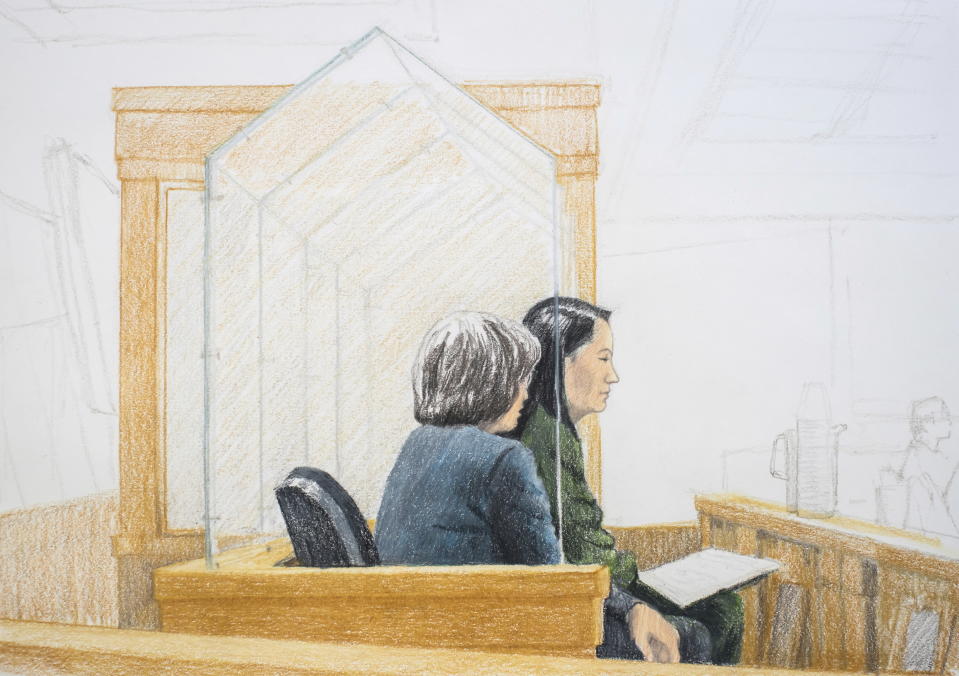 In this courtroom sketch, Meng Wanzhou, right, the chief financial officer of Huawei Technologies, sits beside a translator during a bail hearing at British Columbia Supreme Court in Vancouver, on Friday, Dec. 7, 2018. Meng faces extradition to the U.S. on charges of trying to evade U.S. sanctions on Iran. She appeared in a Vancouver court Friday to seek bail. (Jane Wolsak/The Canadian Press via AP)