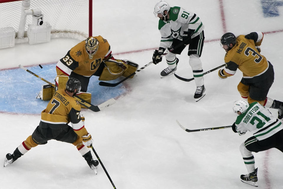 Dallas Stars left wing Jason Robertson (21) scores on Vegas Golden Knights goaltender Adin Hill (33) during the second period of Game 2 of the NHL hockey Stanley Cup Western Conference finals Sunday, May 21, 2023, in Las Vegas. (AP Photo/John Locher)