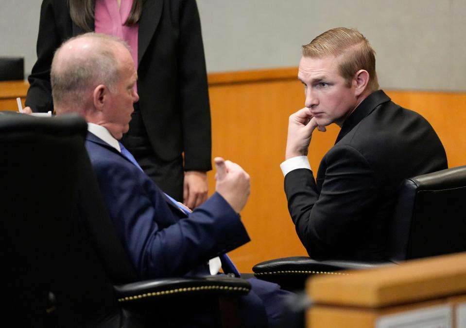 Officer Christopher Taylor, right, talks to his attorney Doug O’Connell during a break in the trial.