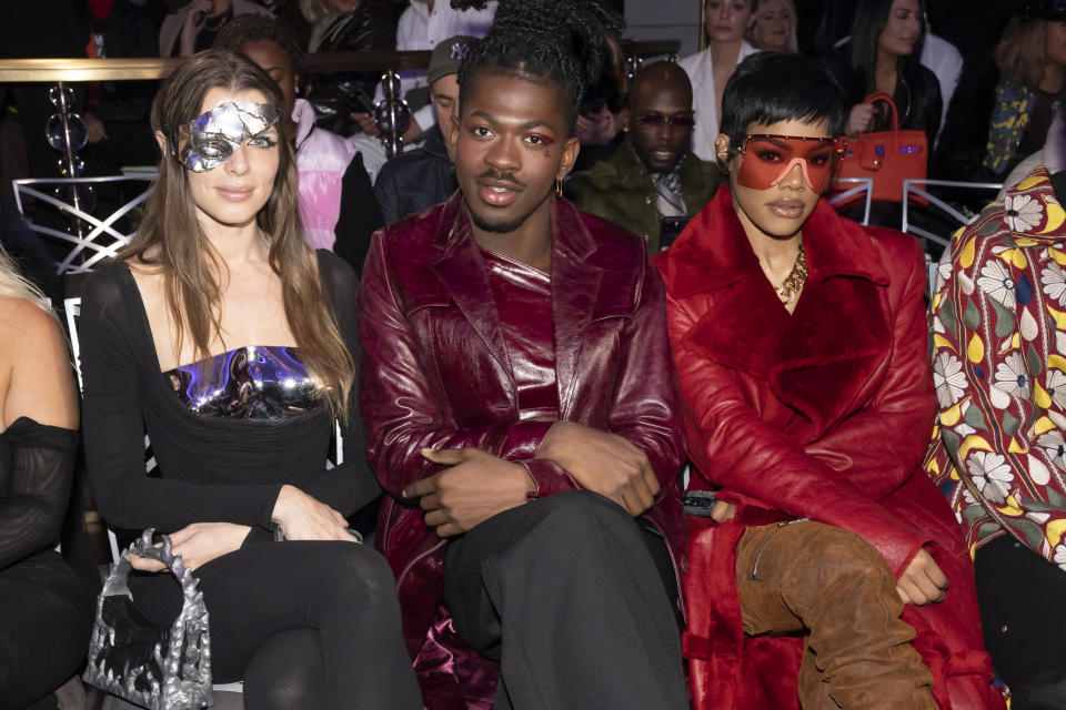 Julia Fox, from left, Lil Nas X and Teyana Taylor attend the LaQuan Smith Fall/Winter 2023 fashion show at the Rainbow Room on Monday, Feb. 13, 2023, in New York. (Photo by Charles Sykes/Invision/AP)