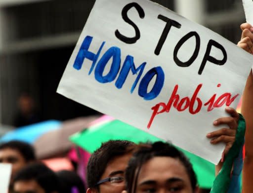 A student hoists an anti-homophobia placard during a rally at the University of the Philippines in the town of Los Banos, Laguna province, south of Manila on July 19. Gay sex in a conservative Catholic society where the influential church forbids the use of condoms is fuelling an alarming rise of HIV infections in the Philippines, experts warn