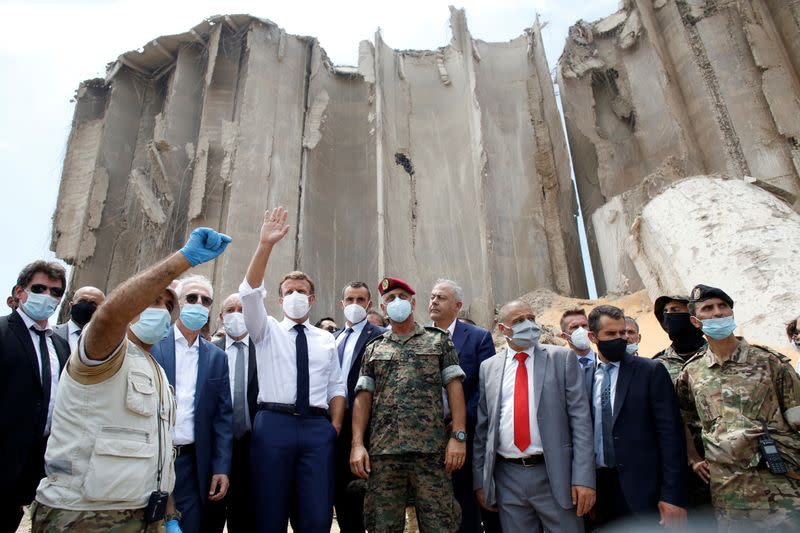 FILE PHOTO: French President Emmanuel Macron gestures as he visits the devastated site of the explosion at the port of Beirut