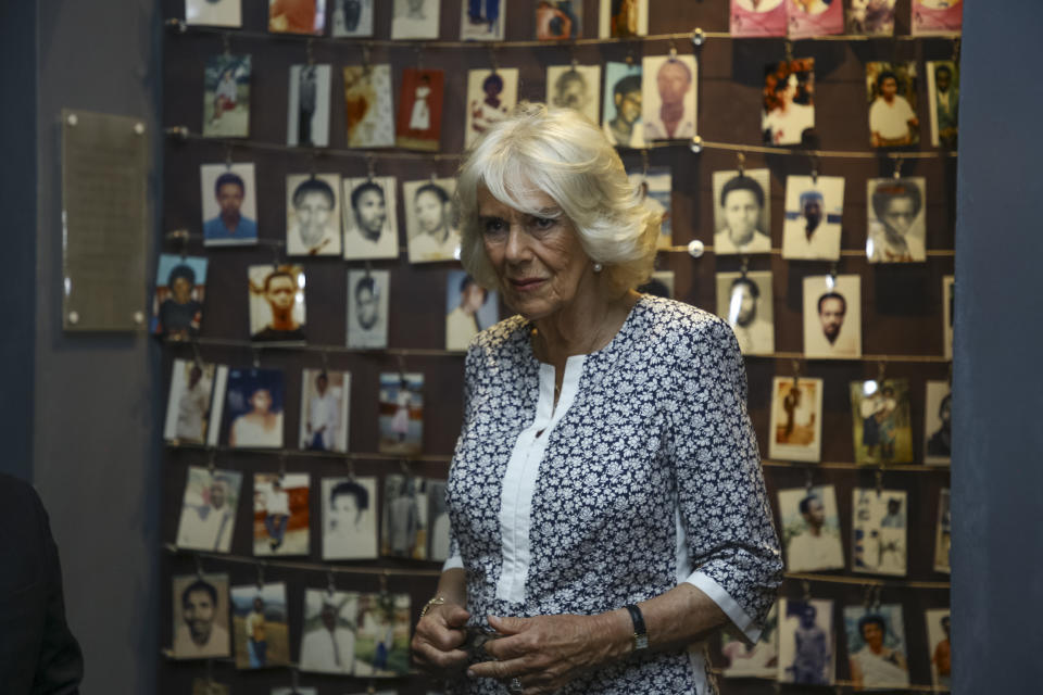 Camilla, Duchess of Cornwall, observes an exhibition of family photographs of some of those who died, at the Kigali Genocide Memorial in the capital Kigali, Rwanda Wednesday, June 22, 2022. Prince Charles has become the first British royal to visit Rwanda, representing Queen Elizabeth II as the ceremonial head of the Commonwealth at a summit where both the 54-nation bloc and the monarchy face uncertainty. (AP Photo)