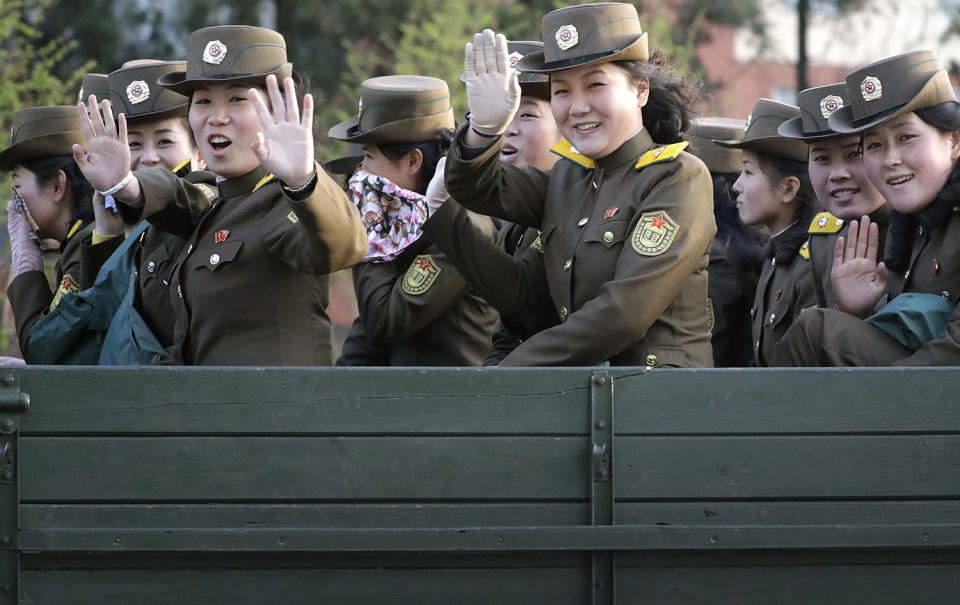 <p>Female North Korean soldiers wave from the back of a truck at oncoming traffic on April 20, 2017, in Pyongyang, North Korea. (Photo: Wong Maye-E/AP) </p>