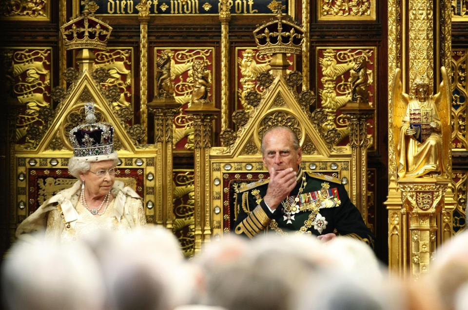 FILE - In this May 25, 2010 file photo, Britain's Queen Elizabeth II sits on the throne beside Prince Philip, right, in the House of Lords prior to delivering the Queen's Speech at the Palace of Westminster in London. Spain's Crown Princess Letizia has a penchant for haute couture. Queen Elizabeth II's Bentley's are spotless. Belgium's King Albert II maintains a sumptuous villa in the south of France. But believe it or not, many of Europe's royals are feeling a pinch of the austerity sweeping the continent as it deals with its debt crisis. (AP Photo/Alastair Grant, Pool-File)