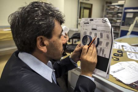 A forensic scientist practises classifying fingerprints at the fingerprint department at Punjab Forensic Science Agency in Lahore January 13, 2015. REUTERS/Zohra Bensemra