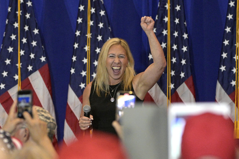 Rep. Marjorie Taylor Greene, R-Ga., cheers with attendees of a rally featuring herself and Rep. Matt Gaetz, R-Fla., Friday, May 7, 2021, in The Villages, Fla. (AP Photo/Phelan M. Ebenhack)