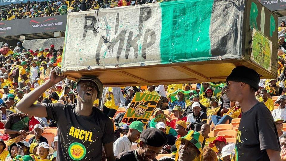 ANC supporters carry coffin