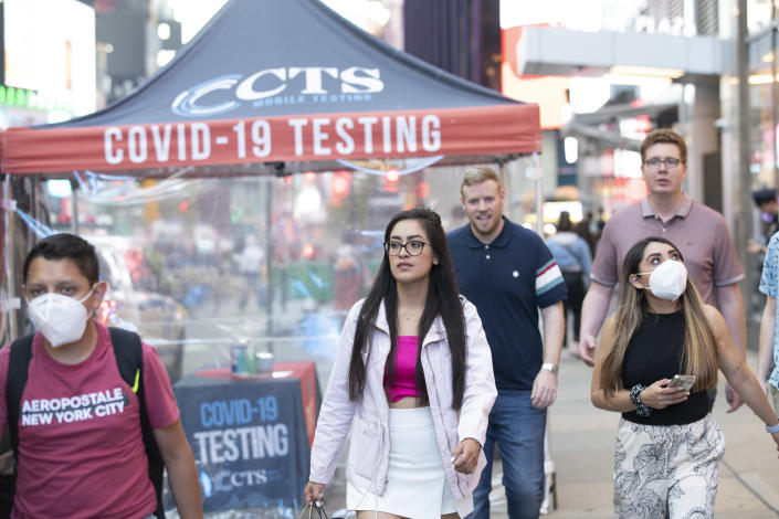 People walk by a Covid-19 testing site at Times Square on May 12, 2022 in New York City. (Liao Pan/China News Service via Getty Images)