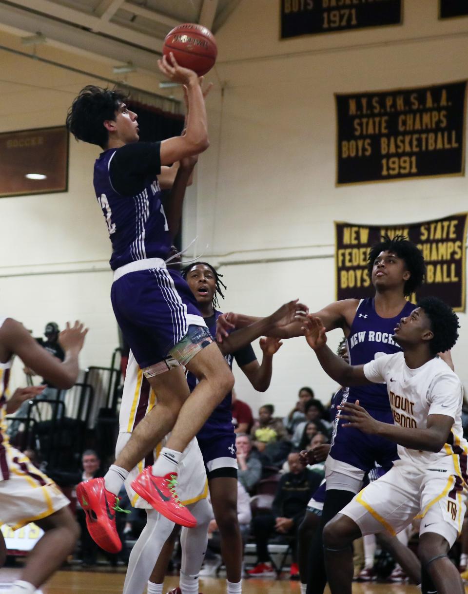 From left, New Rochelle's Kas Mirza (12) puts up a shot against Mt. Vernon during boys basketball action at Mt. Vernon High School Jan. 11, 2024. New Rochelle won the game 64-60.
