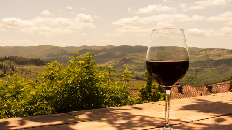 wine glass overlooking Tuscany hills