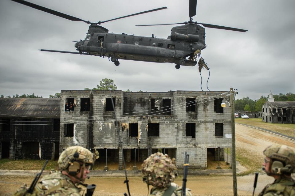 Soldiers part of a 75th Ranger Regiment platoon rappel down ropes suspended from a MH-47 Chinook flown by the 160th Special Operations Aviation Regiment during U.S. Army Special Operations Command's annual capabilities exercise in April 2023, at then-Fort Bragg.