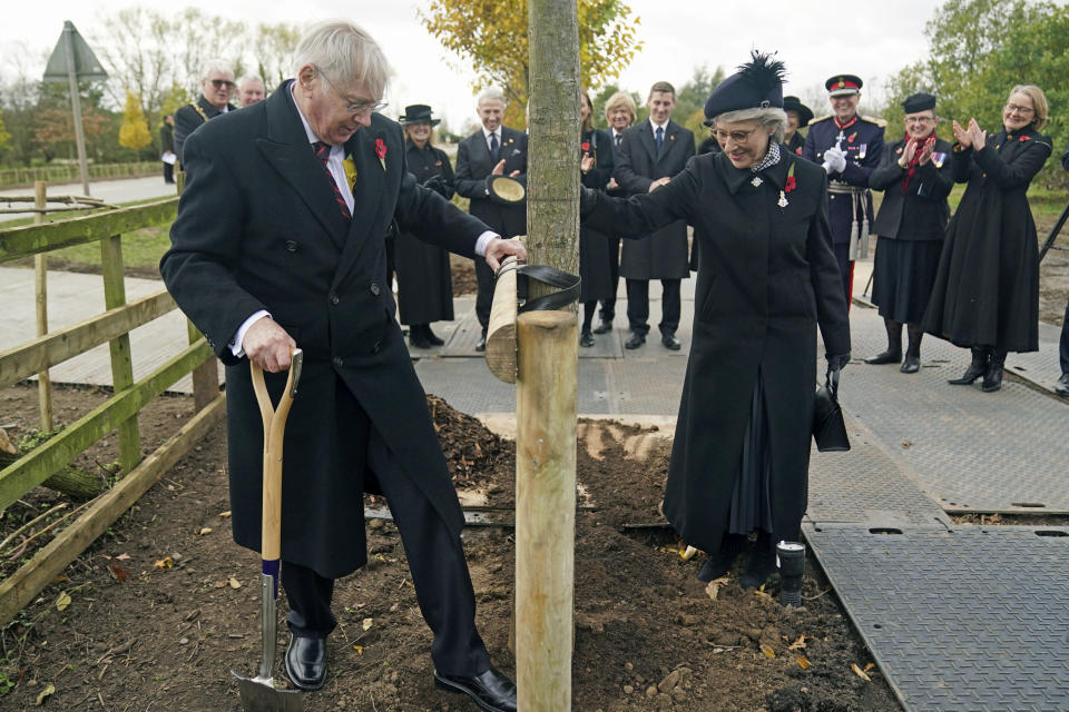 Britain's Prince Richard, Duke of Gloucester and his wife Birgitte, Duchess of Gloucester plant the last of 27 new Elm, Oak and Lime trees along the avenue leading to the entrance of the National Memorial Arboretum, as part of The Queen's Green Canopy, a nationwide Platinum Jubilee initiative to plant over a million trees in honour of Queen Elizabeth II, after an Armistice Day service, at the Armed Forces Memorial in Alrewas, England, Friday, Nov. 11, 2022. (Jacob King/PA via AP)