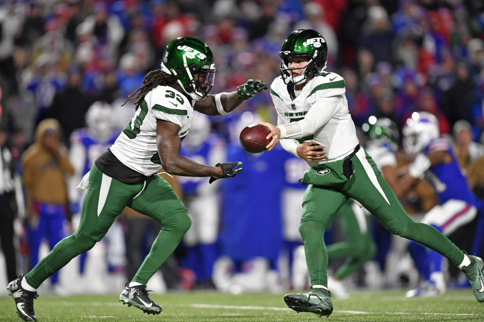 New York Jets quarterback Zach Wilson (2) hands off to running back Dalvin Cook during the second half of an NFL football game against the Buffalo Bills in Orchard Park, N.Y., Sunday, Nov. 19, 2023. (AP Photo/Adrian Kraus)