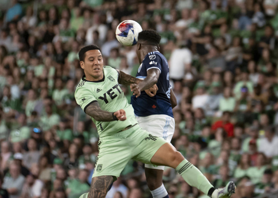 Austin FC midfielder Sebastian Driussi, left, goes up for a head ball against Vancouver Whitecaps defender Javain Brown during the second half of an MLS soccer match Saturday, April 15, 2023, in Austin, Texas. The game ended 0-0. (AP Photo/Michael Thomas)