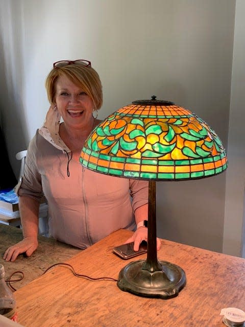 Gracie Jones admires the stained glass in a lamp.