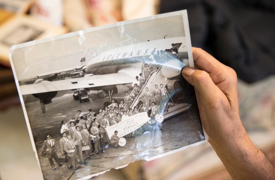 In a photo for a 2016 American-Statesman article, former UT basketball player Albert Almanza holds an old photo of his Mexico Olympic teammates before they traveled to Rome for the 1960 Olympics.