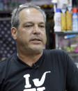 Jay Work talks to a reporter at his Grateful J's smoke shop, Thursday, Jan. 12, 2017, in Margate, Fla. High-end German glass water pipe maker Roor and its American licensee are filing lawsuits against smoke shops and mom-and-pop convenience stores in Florida, California and New York alleging that they are selling Roor counterfeits, violating its trademark. (AP Photo/Alan Diaz)