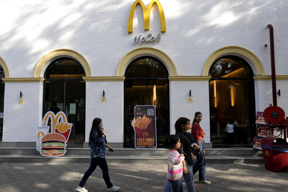 People walk past a McDonald's outlet in New Delhi, India, Friday, March 15, 2024. System failures at McDonald’s were reported worldwide Friday, shuttering some restaurants for hours and leading to social media complaints from customers, in what the fast food chain called a “technology outage” that was being fixed. (AP Photo/Manish Swarup)
