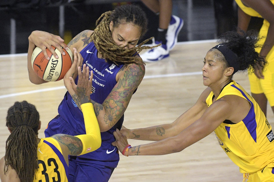 Phoenix Mercury center Brittney Griner, center, fights for position between Los Angeles Sparks center Seimone Augustus (33) and forward Candace Parker, right, during the second half of a WNBA basketball game Saturday, July 25, 2020, in Ellenton, Fla. (AP Photo/Phelan M. Ebenhack)