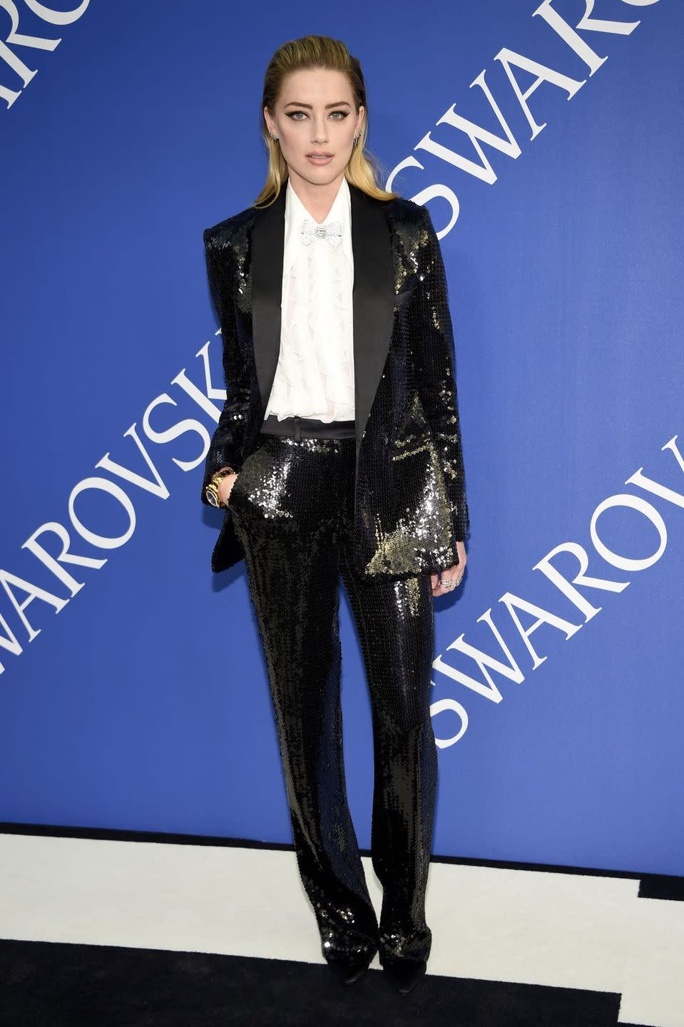 <p><strong>June 2018</strong> Amber Heard sparkled in a sequin Michael Kors suit.</p>