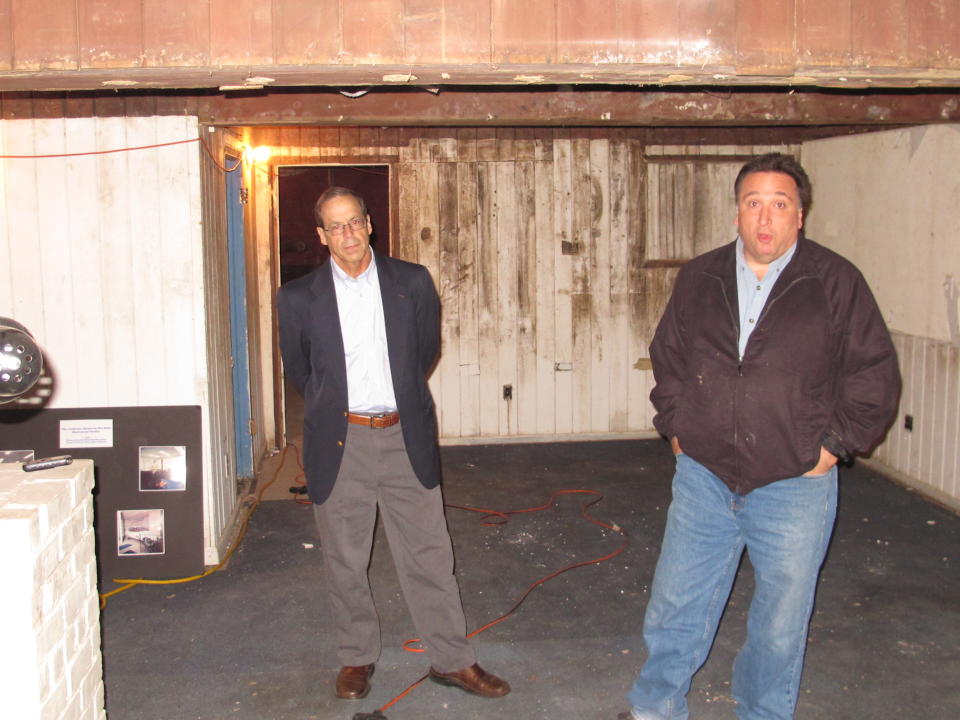 In this Wednesday, Oct. 23, 2013 photo, Steve Fulgoni, right, and Ron Stein, two of the organizers of an effort to restore the home of jazz legend John Coltrane, stand inside the basement which was used as a recording studio by Coltrane and his wife. Years of neglect left the home infested with mold and in dire condition, Fulgoni said. However, much of the interior was essentially unchanged from when the Coltranes lived there in the 1960s. (AP Photo/Frank Eltman)