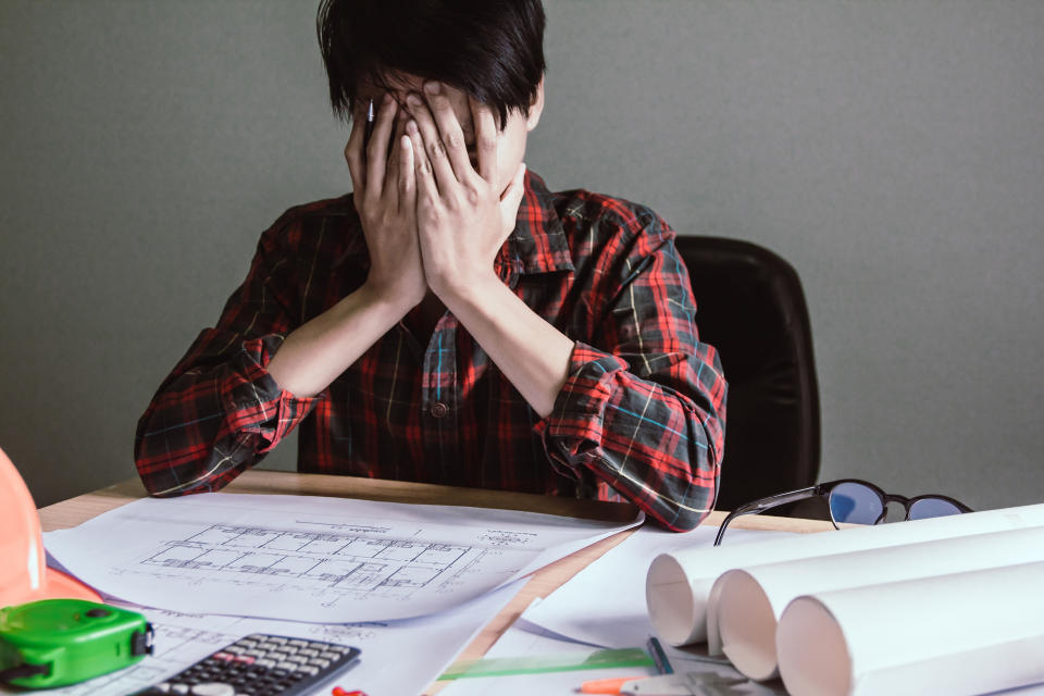 Asian young man are stress worry probleme working sitting on chair in office.