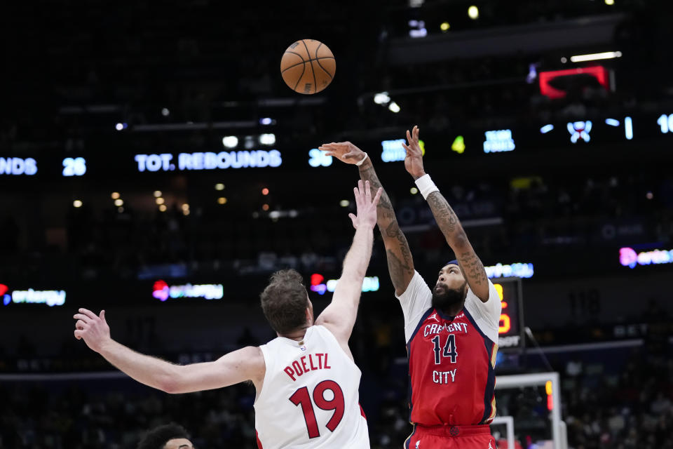 New Orleans Pelicans forward Brandon Ingram (14) takes a 3-point shot against Toronto Raptors center Jakob Poeltl (19) in the second half of an NBA basketball game in New Orleans, Monday, Feb. 5, 2024. Ingram had a career high eight 3-pointers and a season high 41 points, as thePelicans won 138-100. (AP Photo/Gerald Herbert)