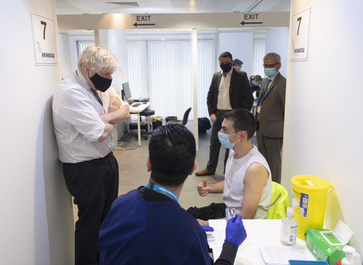 Prime Minister Boris Johnson during a visit to a Covid vaccination centre at the Rainbow Pharmacy in the Open University Campus, Walton Hall, Milton Keynes, Buckinghamshire. Picture date: Wednesday December 29, 2021.