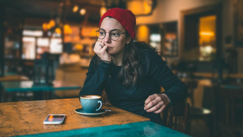 Lovely modern girl enjoying her time at a coffee shop.