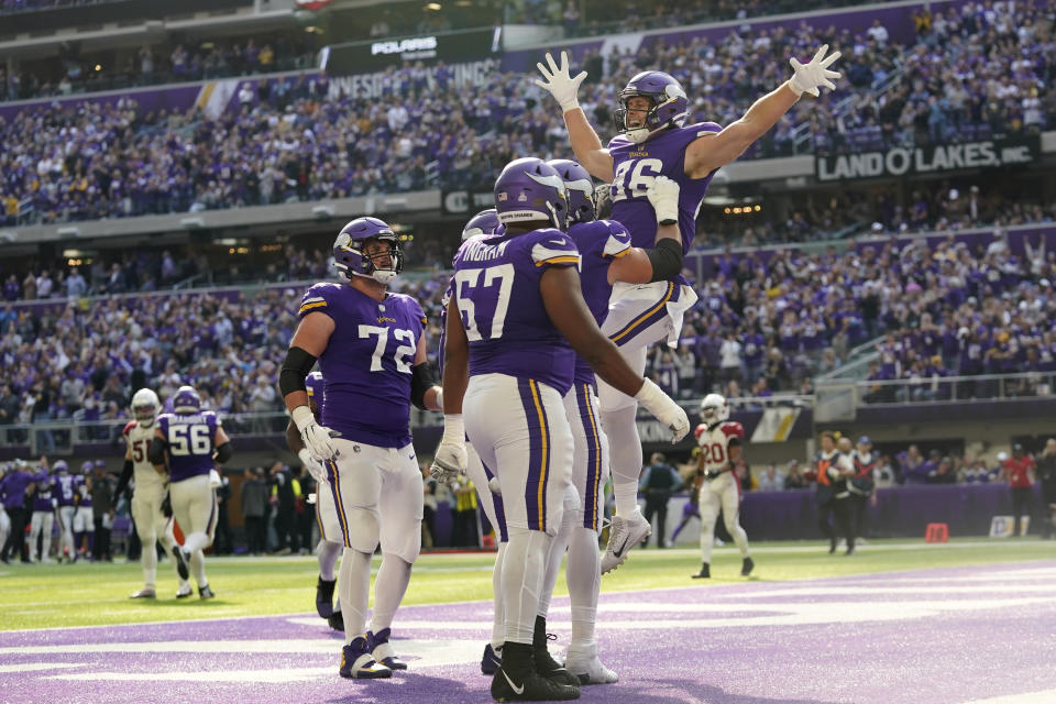 Minnesota Vikings tight end Johnny Mundt (86) celebrates with teammates after catching a 1-yard touchdown pass during the first half of an NFL football game against the Arizona Cardinals, Sunday, Oct. 30, 2022, in Minneapolis. (AP Photo/Abbie Parr)