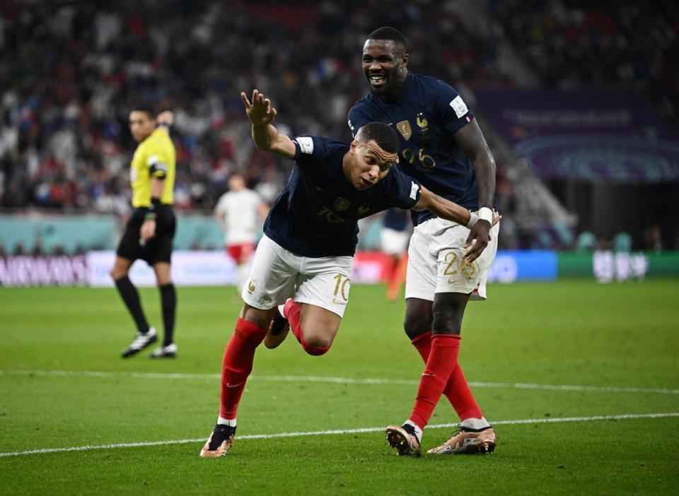 Kylian Mbappe celebrates scoring his second goal against Poland (Reuters)