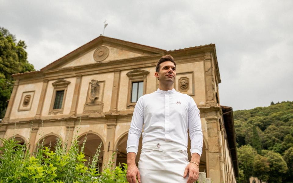 La Loggia's head chef Alessandro Cozzolino stands in front of Villa San Michele's grand facade, which i soften attributed to Michelangelo