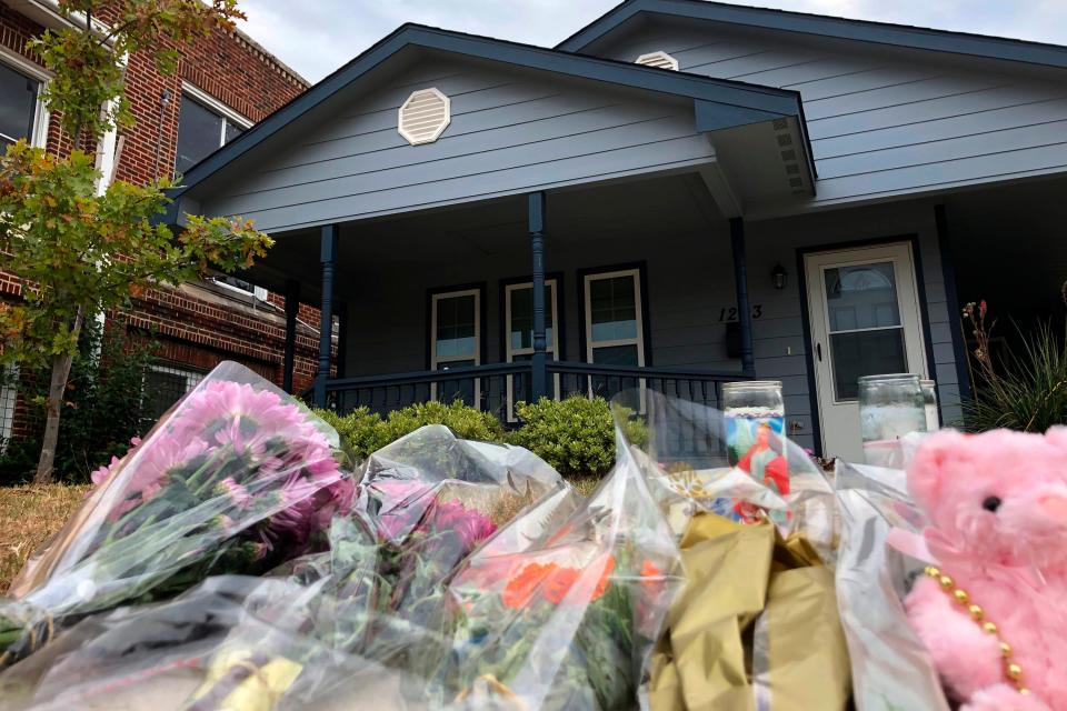 Bouquets of flowers and stuffed animals pile up Oct. 14, 2019, outside the Fort Worth home where Atatiana Jefferson, 28, was shot to death by a police officer.