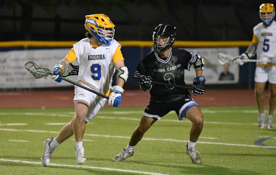 Agoura High's Cody Meehan tries to get around a Sierra Canyon defender during the Chargers' 11-9 win at home in a CIF-Southern Section Division 2 semifinal game on Tuesday, May 7, 2024. Agoura will play Mira Costa in the championship game on Friday.
