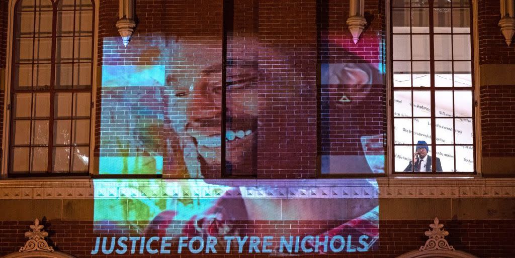 a photo of tyre nichols projected onto a building