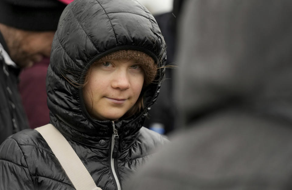 Swedish climate campaigner Greta Thunberg looks on during a protest rally in Erkelenz, Germany, Saturday, Jan. 14, 2023. Ahead of a demonstration in which she takes part nearby on Saturday, Thunberg on Friday visited the tiny village of Luetzerath and took a look at the nearby Garzweiler open coal mine. (AP Photo/Michael Probst)
