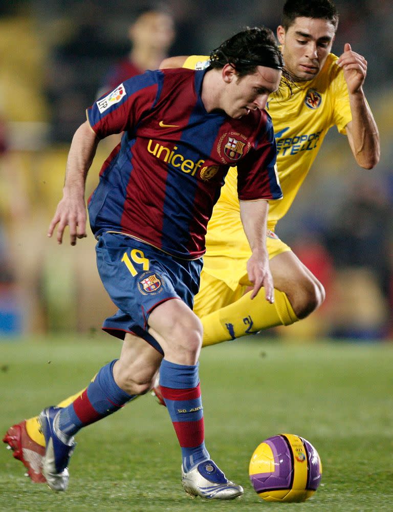 <p>Lionel Messi (L), pictured here with Bruno Soriano, during the Copa del Rey match at the El Madrigal stadium on Jan. 24, 2008 in Villarreal, Spain. The athlete played in a apaur of silver and navy cleats.</p>