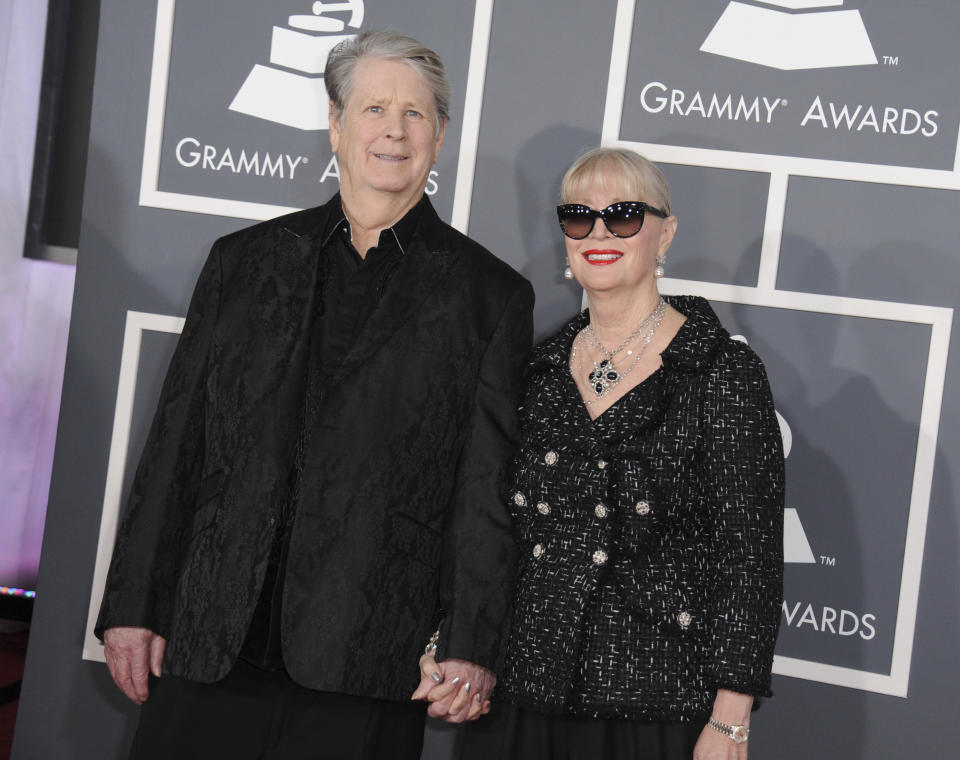 FILE - Musician Brian Wilson, left, and Melinda Ledbetter Wilson arrive at the 55th annual Grammy Awards on Sunday, Feb. 10, 2013, in Los Angeles. Ledbetter Wilson, the longtime wife and manager of Brian Wilson whom the Beach Boys co-founder often credited for stabilizing his famously troubled life, has died at age 77. (Photo by Jordan Strauss/Invision/AP, File)