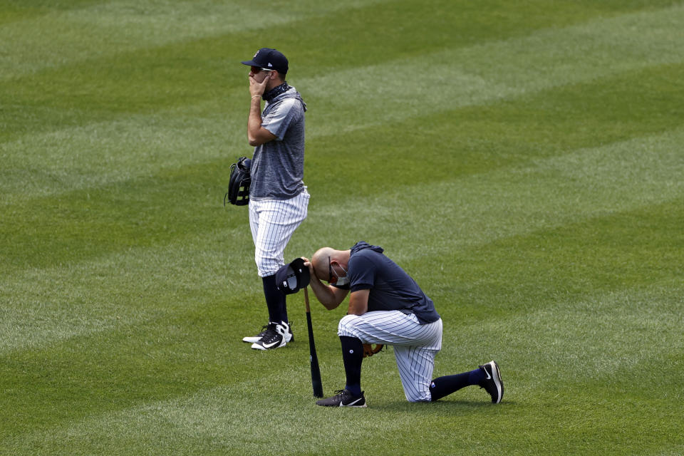 New York Yankees players react after Masahiro Tanaka was hit by a line drive during a baseball workout at Yankee Stadium in New York, Saturday, July 4, 2020. (AP Photo/Adam Hunger)