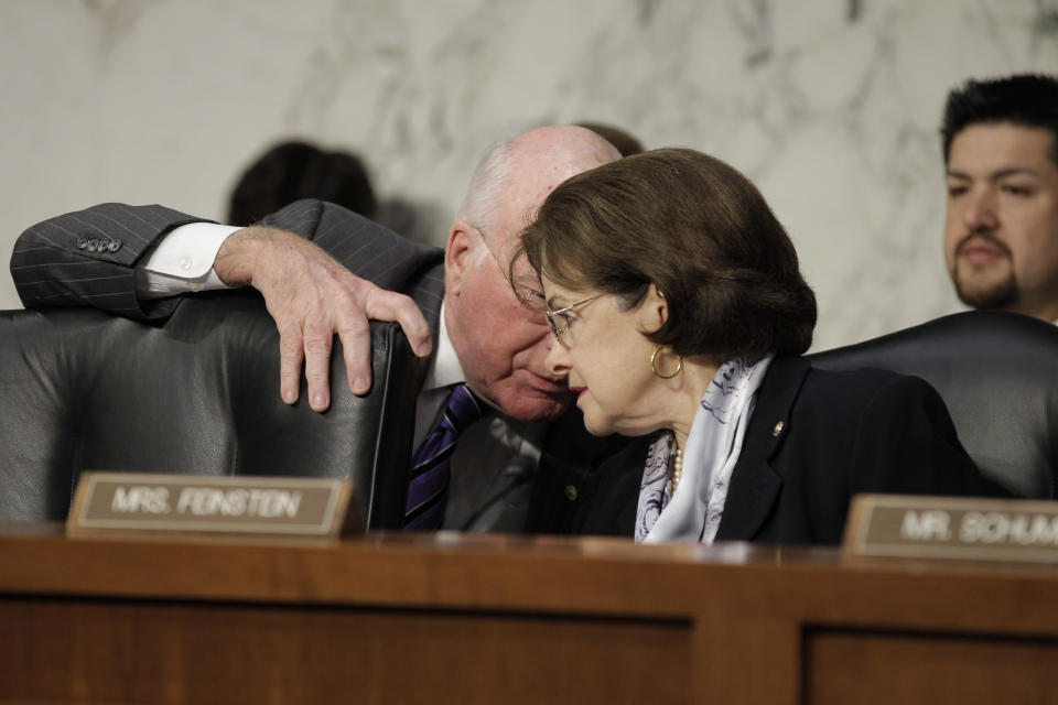FILE - Sen. Patrick Leahy, chairman of the Senate Judiciary Committee, left, leans in to speak with Sen. Dianne Feinstein, D-Calif., during a hearing to assess the impact of the Defense of Marriage Act, DOMA, which Feinstein is trying to repeal, on Capitol Hill in Washington, Wednesday, July 20, 2011. After Feinstein, the nation’s oldest sitting U.S. senator, died at age 90, LGBTQ+ leaders are lauding her as a longtime friend dating to a time when not many could be found. (AP Photo/J. Scott Applewhite, File)