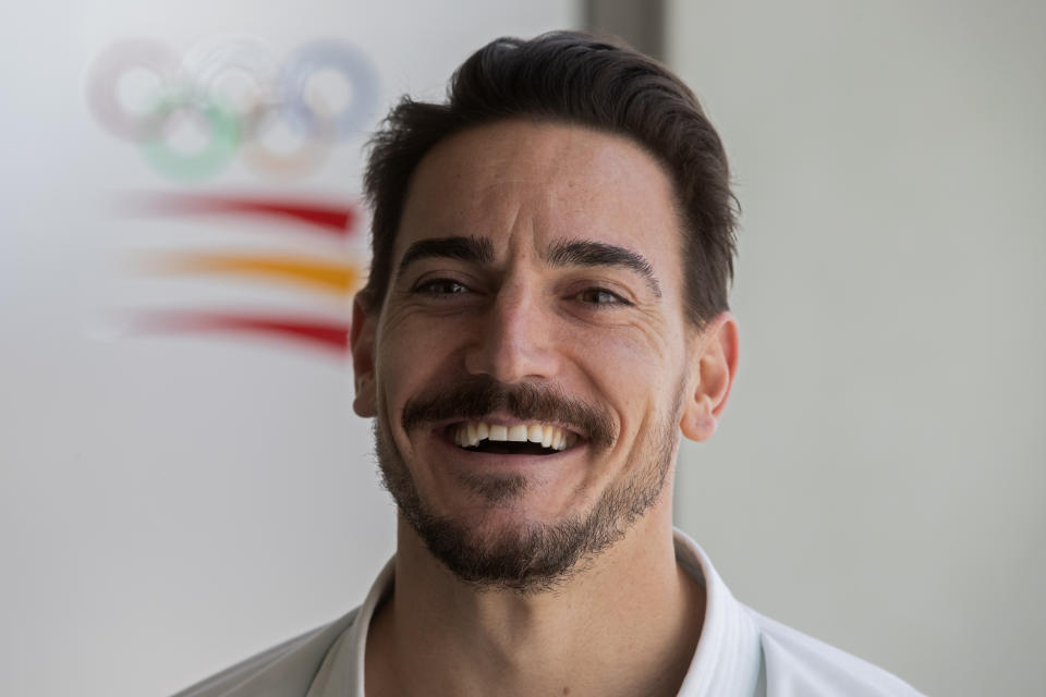 Spanish karate athlete Damian Quinteros smiles during an interview with The Associated Press in Madrid, Spain, Friday, Feb. 7, 2020. More than five years ago, one of Spain's most successful karate athletes was splitting his time between practice, school and his day job as an aeronautical engineer. Now, nearly five months before the Tokyo Games, Quintero is a full-time karateka and a top contender for the gold medal in Japan. (AP Photo/Paul White)