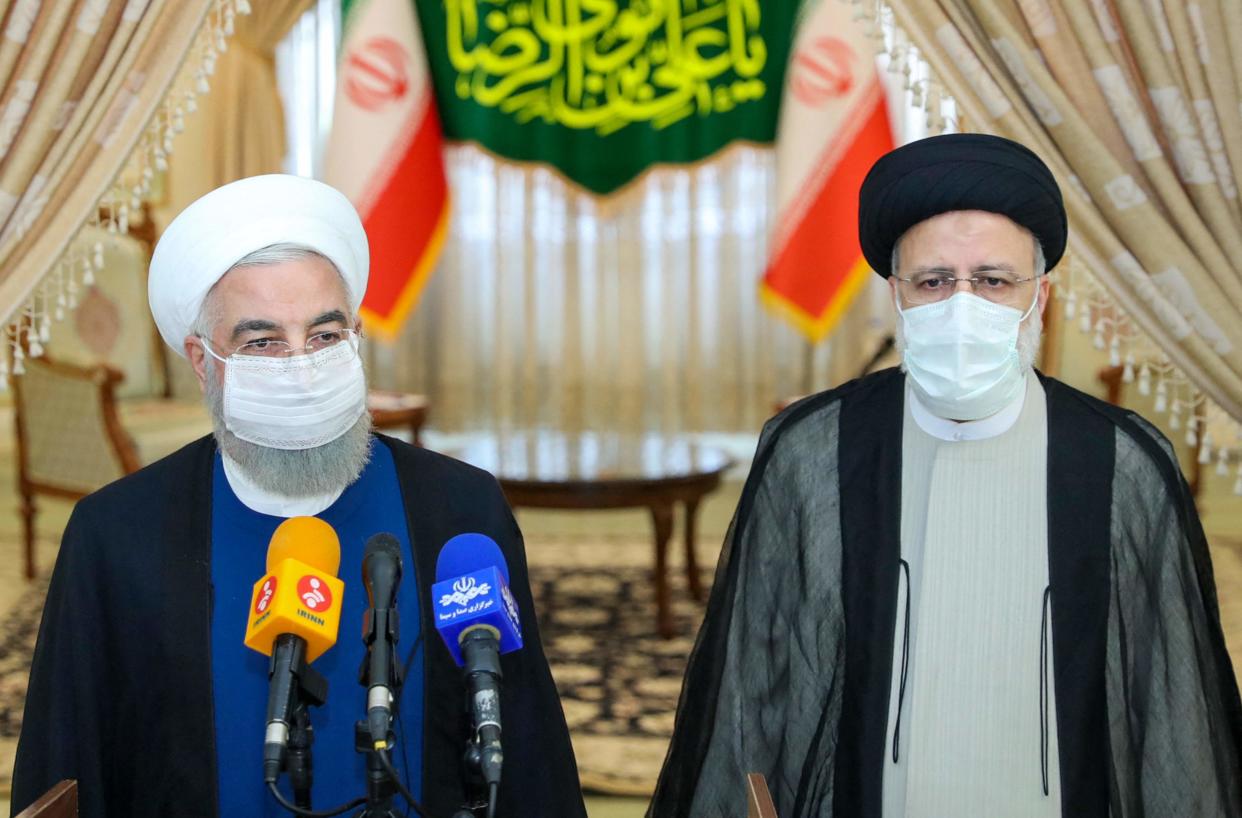 Outgoing president Hassan Rouhani (L) takes part in a press conference with president-elect Ebrahim Raisi  (Iranian Presidency/AFP/Getty)