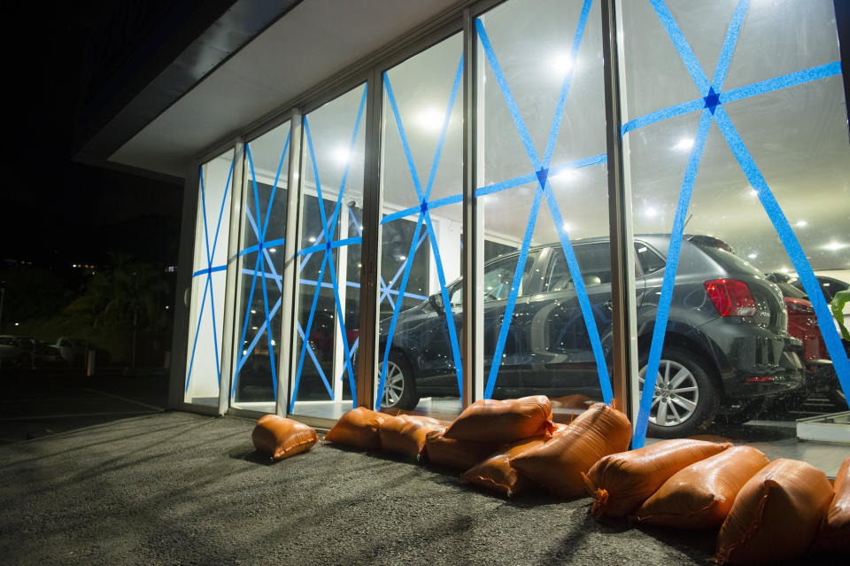 Windows of a car dealer are protected by tape and sandbags, on September 4, 2017 in Marigot.&nbsp;