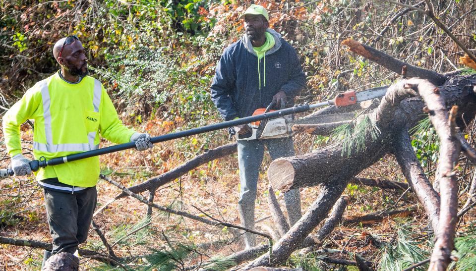 Downed trees are cleared after overnight fatal storms hit the Lower Wetumpka Road area in Montgomery, Ala., on Wednesday morning November 30, 2022. 