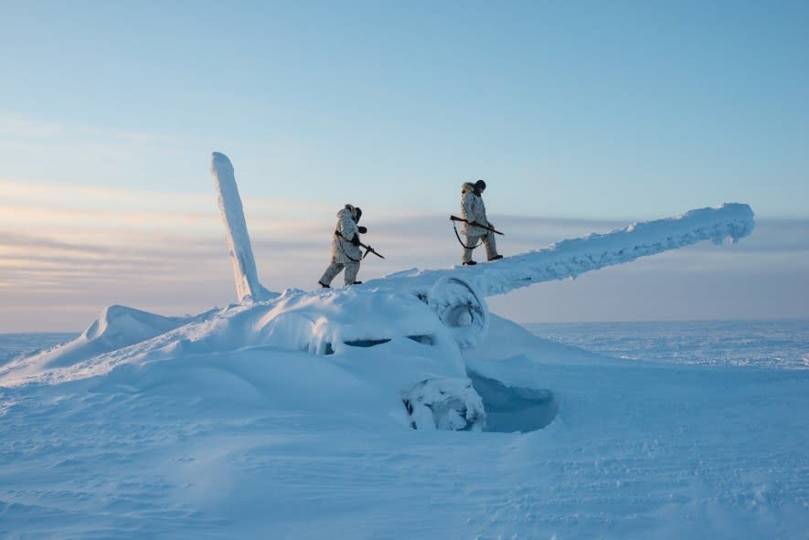 Canadian soldiers climb on the wreckage of a plane, roughly a thousand miles south of the North Pole, to scout the area during an Arctic survival course on Cornwallis Island. As the Arctic warms and tensions over its future rise, the Canadian and US militaries have stepped up operations in the region. (National Geographic/Louie Palu)