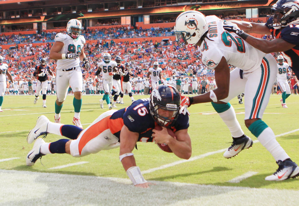 MIAMI GARDENS, FL - OCTOBER 23: Quarterback Tim Teebow #15 of the Denver Broncos dives against the Miami Dolphins to end the game to overtime at Sun Life Stadium on October 23, 2011 in Miami Gardens, Florida. Denver defeated Miami 18-15. (Photo by Marc Serota/Getty Images)