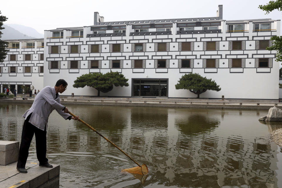 A worker cleans the pond at the Xiangshan hotel designed by Chinese-American architect I.M. Pei and built in 1982 in Beijing, China on Friday, May 17, 2019. Pei, the globe-trotting architect who revived the Louvre museum in Paris with a giant glass pyramid and captured the spirit of rebellion at the multi-shaped Rock and Roll Hall of Fame, has died at age 102, a spokesman confirmed Thursday. (AP Photos/Ng Han Guan)